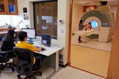 Jungmeen Kim-Spoon and Brooks Casas analyze brain scans of a research participant.